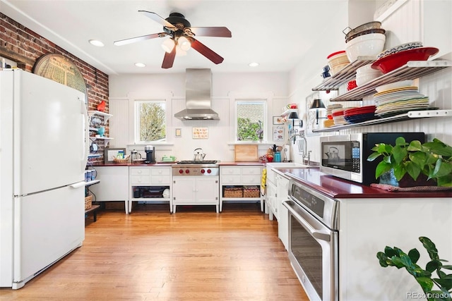 kitchen featuring open shelves, stainless steel appliances, white cabinetry, a wealth of natural light, and range hood