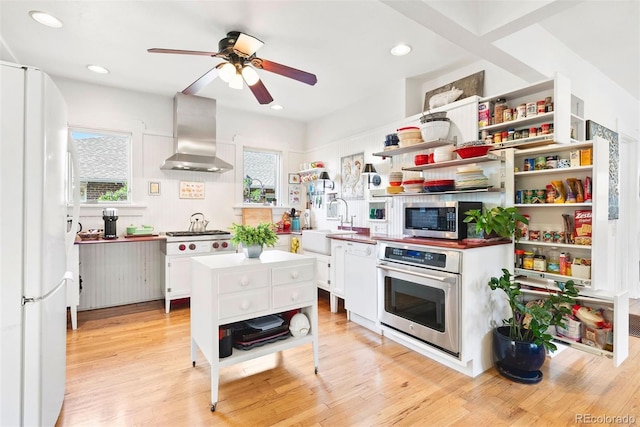 kitchen featuring ceiling fan, appliances with stainless steel finishes, open shelves, white cabinets, and wall chimney exhaust hood