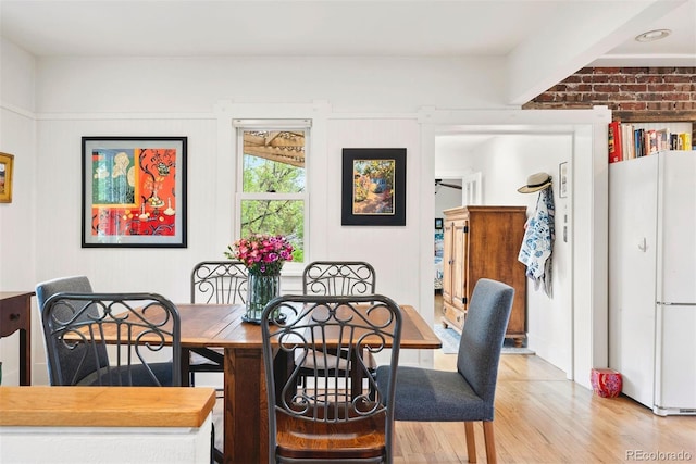 dining room with light wood-style flooring
