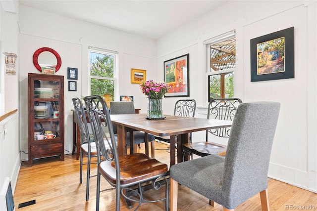 dining room with light wood-style floors and a wealth of natural light