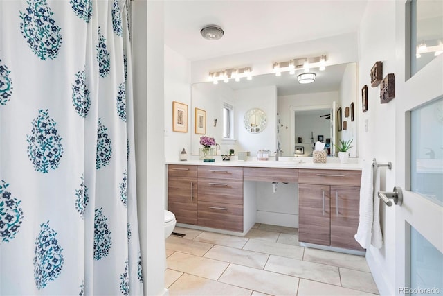 bathroom with vanity, tile patterned floors, toilet, and a shower with curtain