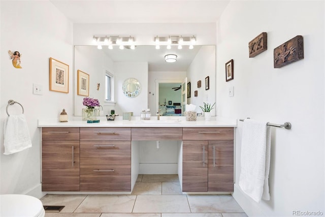bathroom with toilet, tile patterned floors, visible vents, and vanity