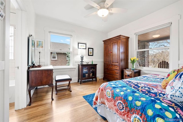 bedroom with a ceiling fan and light wood-type flooring