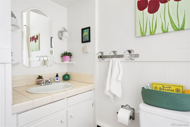 bathroom featuring toilet and vanity