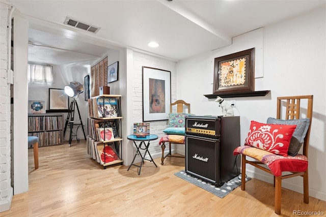 sitting room with visible vents and wood finished floors