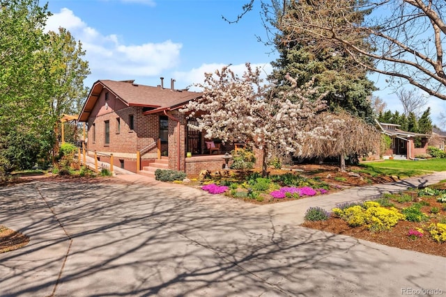 view of side of home with brick siding and concrete driveway