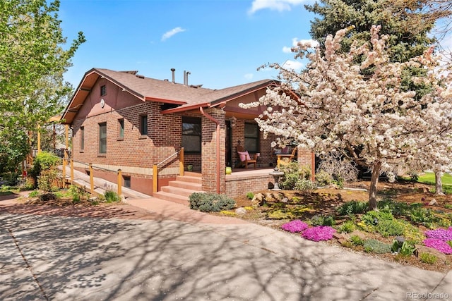 view of front of property with covered porch and brick siding