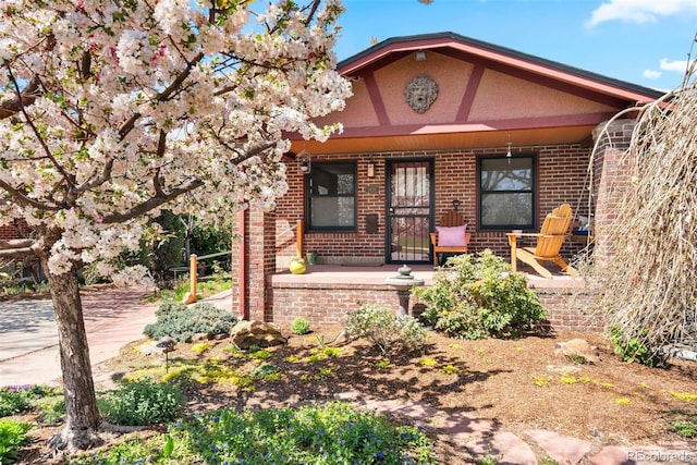view of front of property with brick siding and covered porch