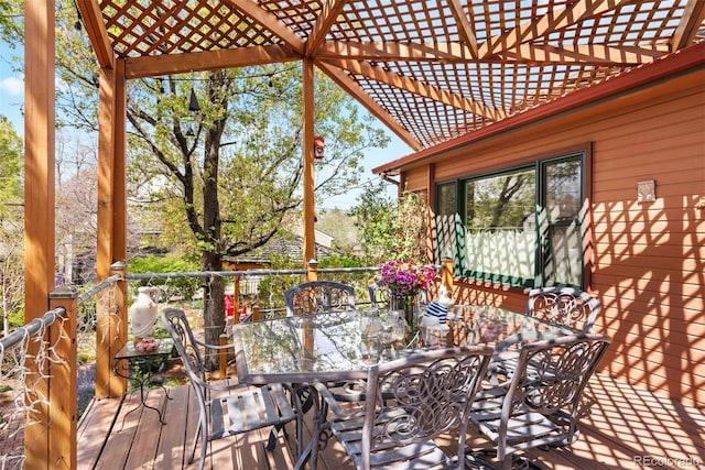 wooden terrace featuring a pergola and outdoor dining area
