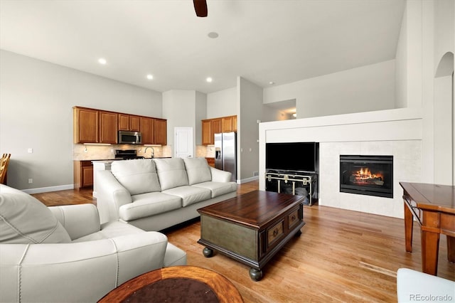 14443 W 88th Dr Unit B, Arvada, CO 80005 - living room with light wood-type flooring, recessed lighting, a fireplace, and ceiling fan
