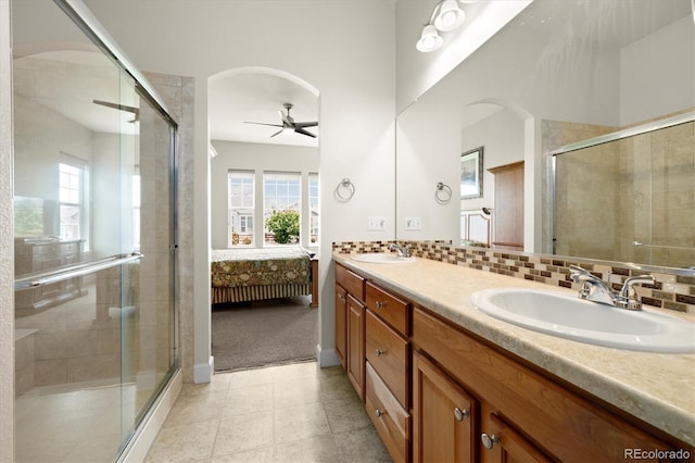 14443 W 88th Dr Unit B, Arvada, CO 80005 - ensuite bathroom featuring ceiling fan, plenty of natural light, double vanity, and a shower stall