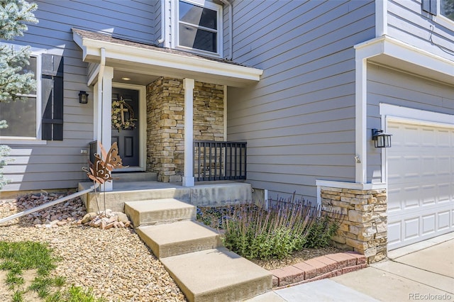9890 Gaylord St, Thornton, CO 80229 - entrance to property with stone siding, an attached garage, and a porch