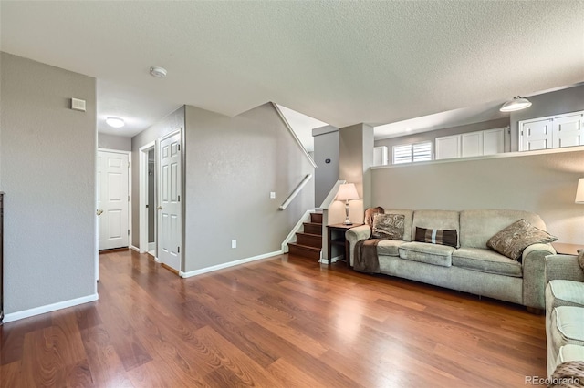 9890 Gaylord St, Thornton, CO 80229 - living room featuring wood finished floors, a textured ceiling, and stairs