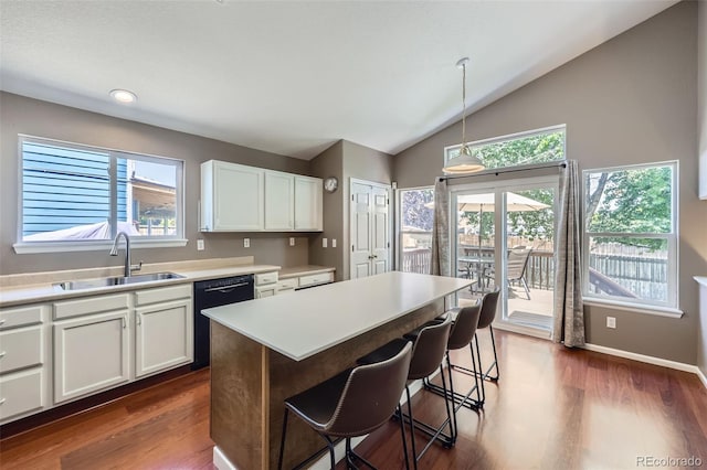 9890 Gaylord St, Thornton, CO 80229 - kitchen with dishwasher, lofted ceiling, a kitchen bar, white cabinetry, and light countertops