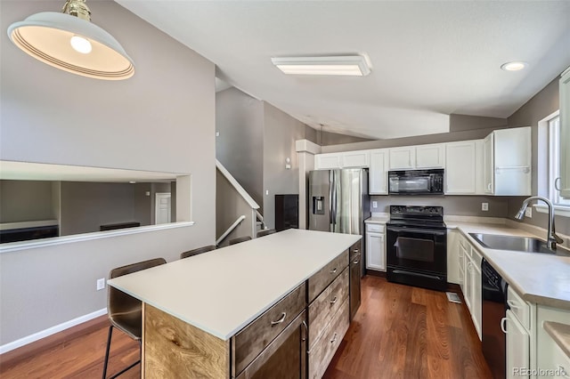 9890 Gaylord St, Thornton, CO 80229 - kitchen with black appliances, lofted ceiling, white cabinetry, dark wood-type flooring, and light countertops