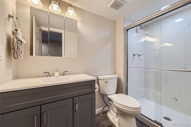 9890 Gaylord St, Thornton, CO 80229 - full bath with a textured wall, vanity, a stall shower, and wood finished floors