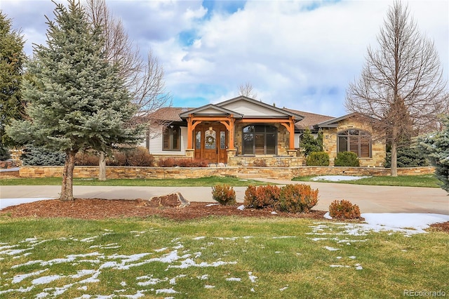 view of front of house featuring a front lawn and covered porch