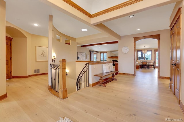 corridor with beam ceiling and light hardwood / wood-style floors