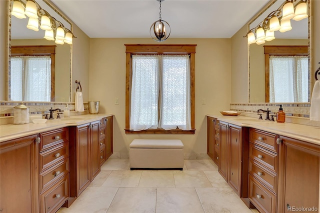 bathroom with tile patterned flooring, vanity, and tasteful backsplash