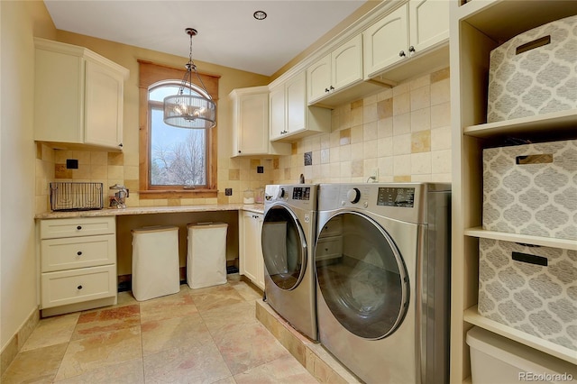 laundry room with cabinets, a chandelier, and independent washer and dryer