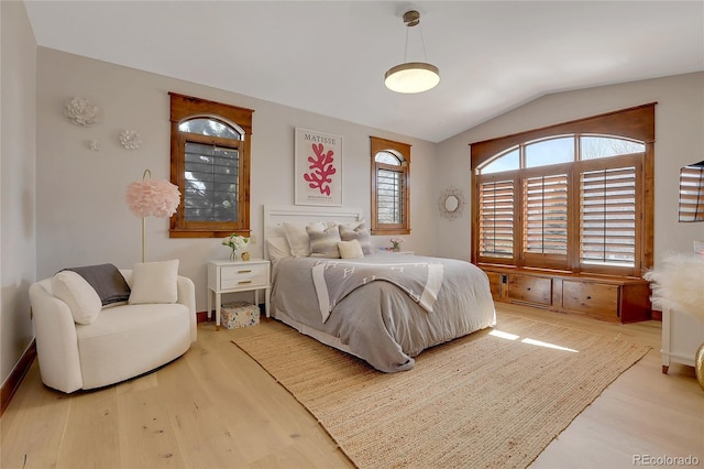 bedroom featuring lofted ceiling and hardwood / wood-style flooring