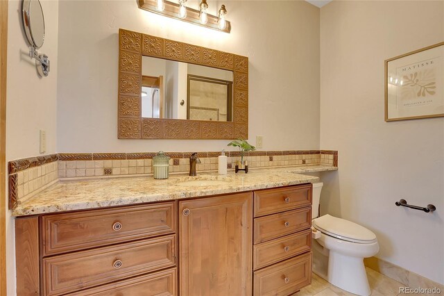 bathroom featuring tile patterned floors, vanity, and toilet