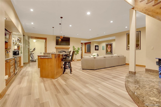 living room featuring bar area and light hardwood / wood-style floors