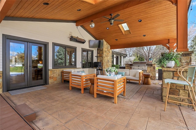 view of patio with french doors, an outdoor hangout area, ceiling fan, area for grilling, and exterior kitchen