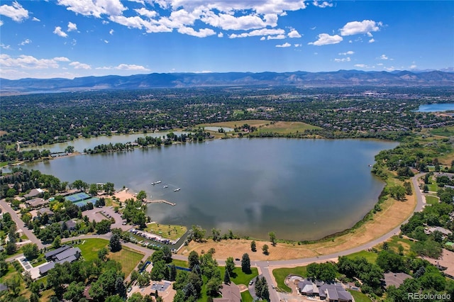 drone / aerial view featuring a water and mountain view