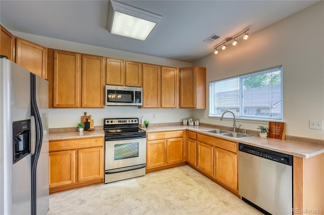 7345 S Nucla St, Aurora, CO 80016 - kitchen featuring stainless steel appliances, light countertops, and rail lighting