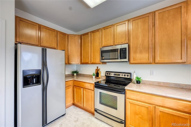 7345 S Nucla St, Aurora, CO 80016 - kitchen featuring appliances with stainless steel finishes, light countertops, and light tile patterned floors