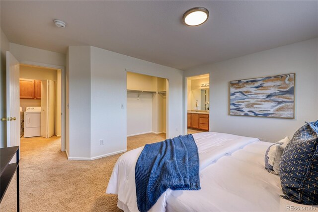 7345 S Nucla St, Aurora, CO 80016 - bedroom featuring washer / clothes dryer, light colored carpet, and a closet