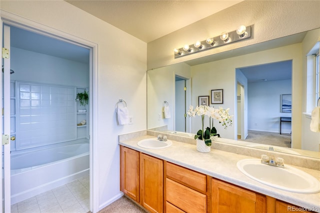 7345 S Nucla St, Aurora, CO 80016 - bathroom with double vanity, a tub to relax in, and tile patterned floors