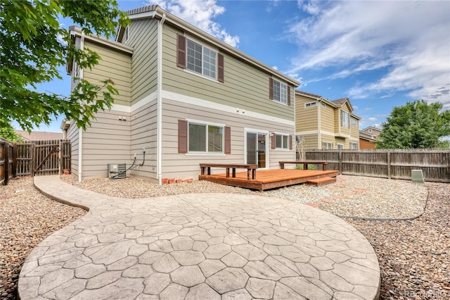 7345 S Nucla St, Aurora, CO 80016 - rear view of property featuring a patio area, a fenced backyard, and a wooden deck