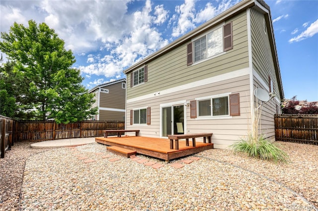 7345 S Nucla St, Aurora, CO 80016 - rear view of house with a fenced backyard and a deck