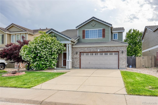 7345 S Nucla St, Aurora, CO 80016 - traditional-style house with driveway, brick siding, a garage, and a tile roof