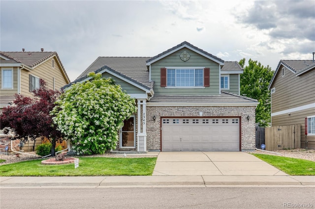 7345 S Nucla St, Aurora, CO 80016 - traditional-style home featuring brick siding, driveway, an attached garage, and a tile roof