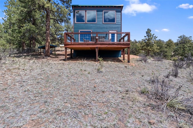 rear view of house featuring a wooden deck