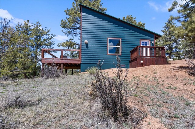 view of property exterior featuring a wooden deck