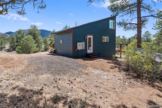 back of property with a mountain view