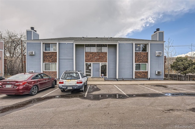 view of building exterior with uncovered parking