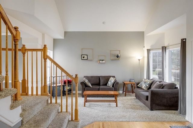 living room with hardwood / wood-style floors and vaulted ceiling