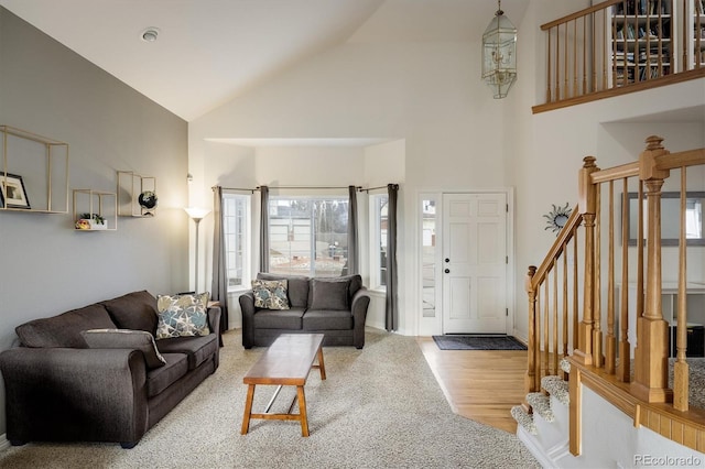 living room featuring light hardwood / wood-style floors and high vaulted ceiling