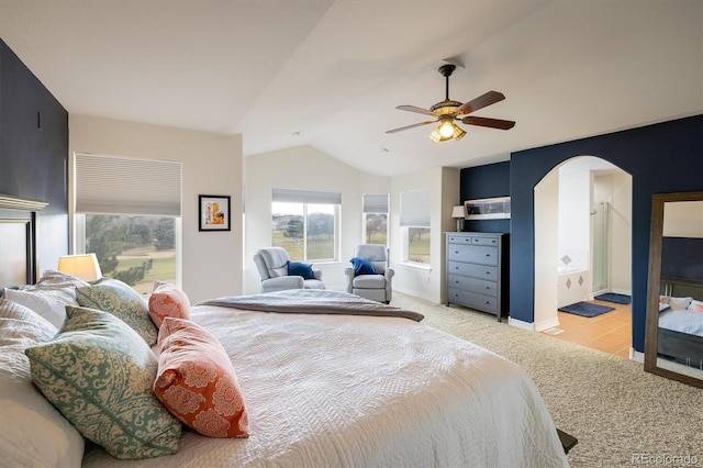 bedroom featuring light colored carpet, vaulted ceiling, and ceiling fan