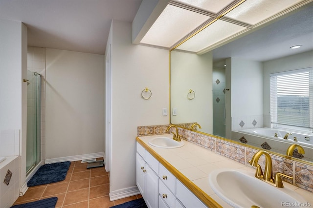 bathroom featuring tile patterned flooring, vanity, and a shower with door