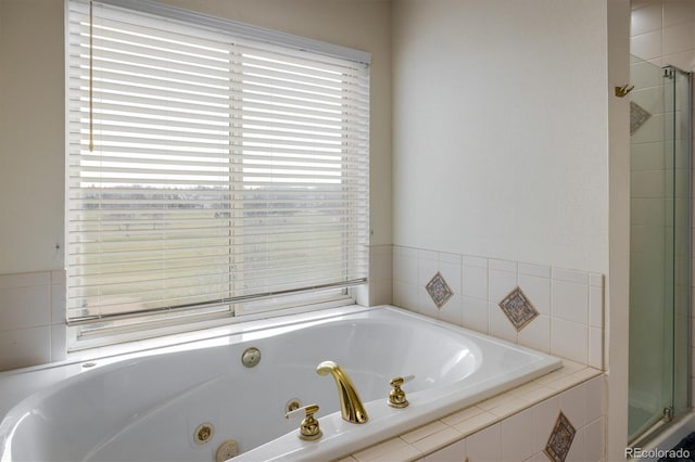 bathroom featuring plus walk in shower and a wealth of natural light