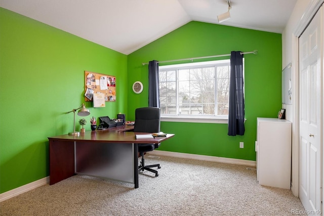 carpeted office featuring vaulted ceiling