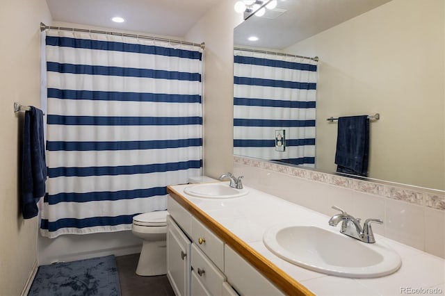 full bathroom with tasteful backsplash, shower / bath combo with shower curtain, vanity, and toilet