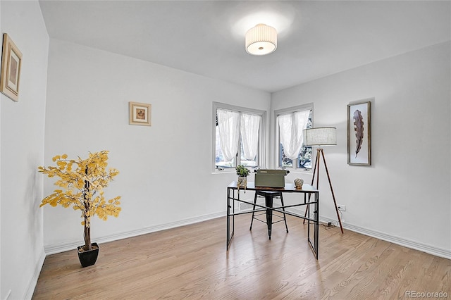 office area featuring light wood-style flooring and baseboards