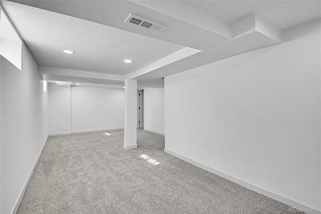 finished below grade area with baseboards, recessed lighting, visible vents, and carpet floors
